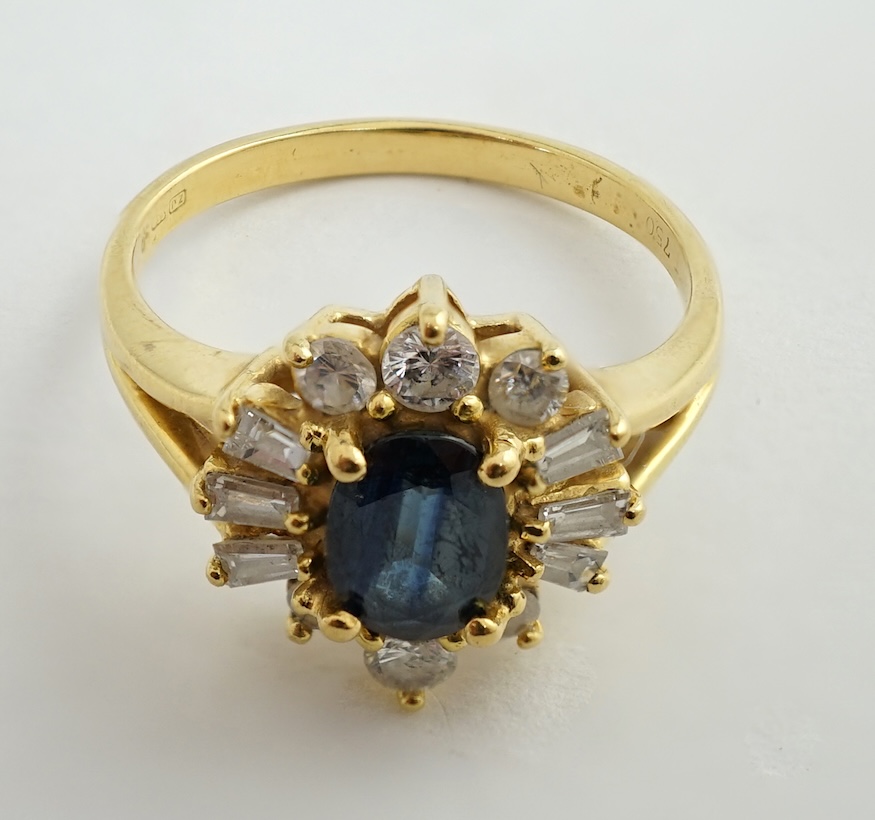 A modern 18ct gold, sapphire and diamond oval cluster ring